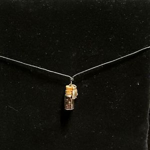 Bottle necklace with elephant charm